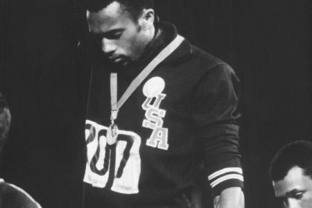 American track and field athletes Tommie Smith (C) and John Carlos (R), first and third place winners in the 200 meter race, protest with the Black Power salute as they stand on the winner's podium at the Summer Olympic games, Mexico City, Mexico, October 19, 1968.  Australian silver medalist Peter Norman stands by.   (Photo by John Dominis/The LIFE Picture Collection/Getty Images)