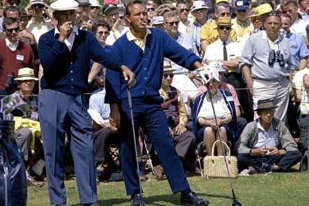 AUGUSTA, GA - APRIL 1966:  (L-R) Ben Hogan and Arnold Palmer smoke as they wait in front of a gallery to play their tee shot on the second hole during the 1966 Masters Tournament at Augusta National Golf Club held April 7-11, 1966 in Augusta, Georgia. (Photo by Augusta National/Getty Images)