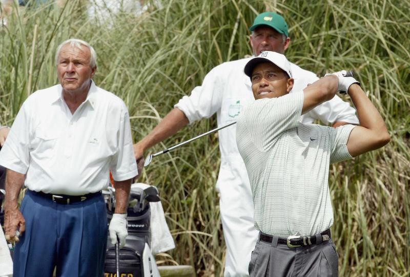 AUGUSTA, UNITED STATES: Golf legend Arnold Palmer(L) watches the tee shot of Tiger Woods 07 April 2004 during the Par 3 contest at Augusta National Golf Club in Augusta, Georgia, site of the Masters Golf Tournament. This is Palmer's 50th and final Master's appearance. AFP PHOTO Timothy A. CLARY (Photo credit should read TIMOTHY A. CLARY/AFP/Getty Images)