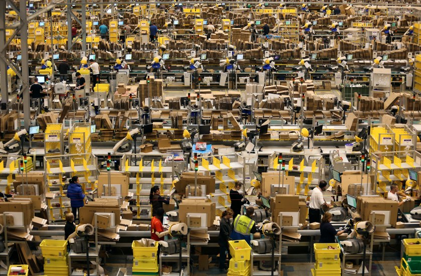 Employees process customer orders ahead of shipping at one of Amazon.com Inc.'s fulfillment centers in Peterborough, U.K., on Tuesday, Nov. 25, 2014. (Chris Ratcliffe/Bloomberg via Getty Images