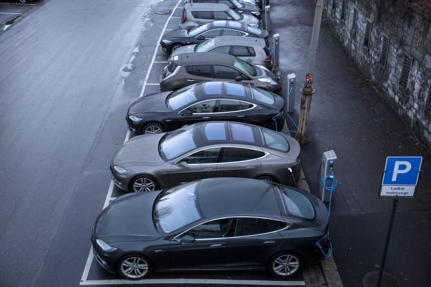 Electric vehicles (EV) sit parked at charging stations at Kongens gate near Akershus festning in Oslo, Norway, on Monday, Nov. 21, 2016. The International Energy Agency forecasts that global gasoline consumption has all but peaked as more efficient cars and the advent of electric vehicles from new players such as Tesla Motors Inc. halt demand growth in the next 25 years. (Fredrik Bjerknes/Bloomberg via Getty Images)