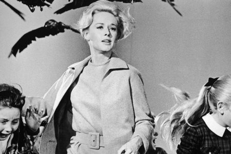 1963, American actor Tippi Hedren and a group of children run away from the attacking crows in a still from the film 'The Birds' directed by Alfred Hitchcock. (Universal Studios/Getty Images)