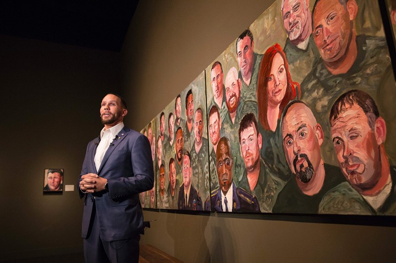 Johnnie Yellock, US Air Force Staff Sergeant, stands in front of a painting of him painted by former US President George W. Bush for the "Portraits of Courage" exhibit, a new exhibit at the George W. Bush Presidential Library and Museum in Dallas, Texas, on February 28, 2017. (Laura Buckman/AFP/Getty Images)