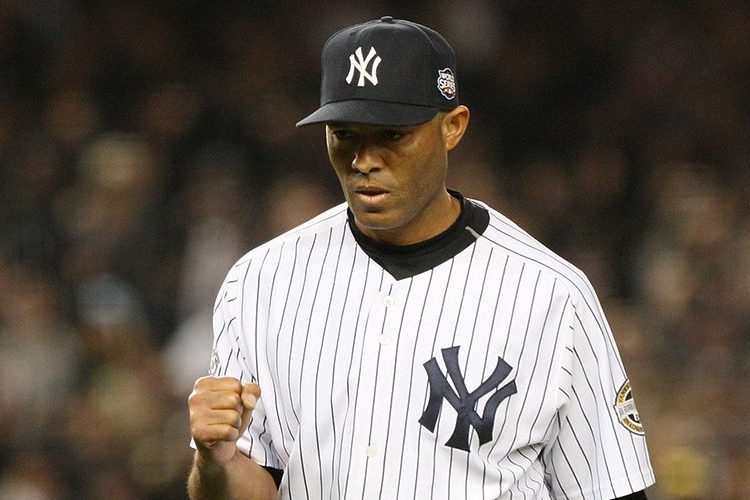 New York Yankees closer Mariano Rivera stands with Hank