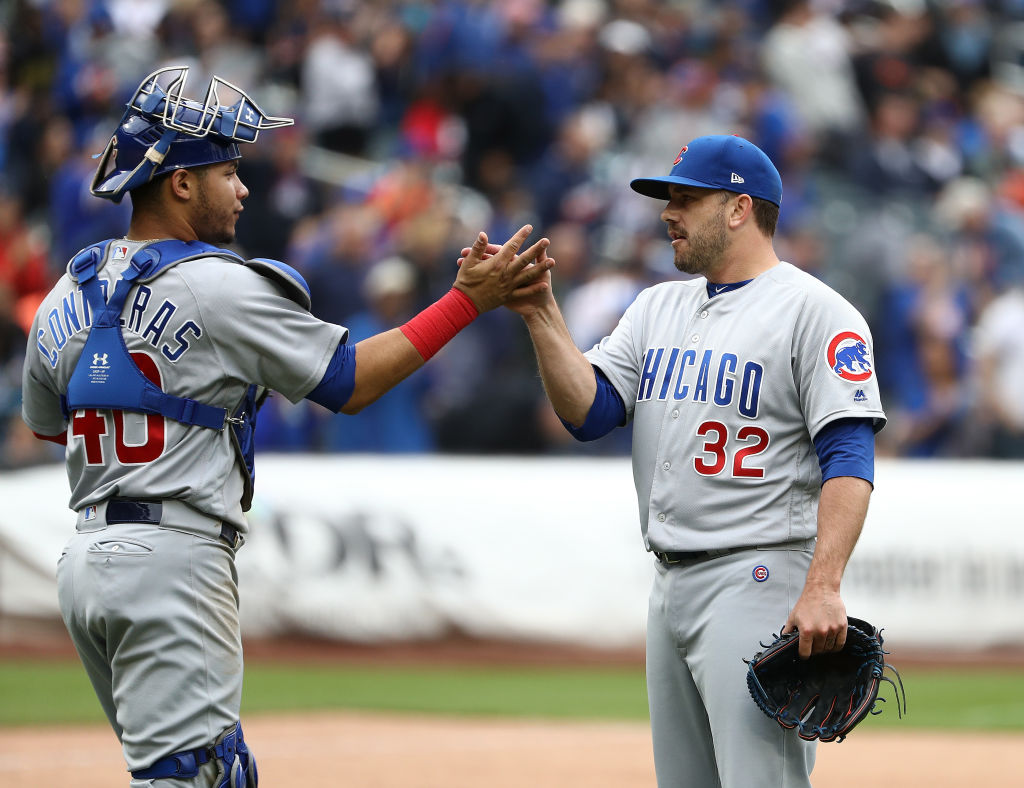 Willson Contreras #40 and Brian Duensing #32 of the Chicago Cubs celebrate a 2-0 win against the New York Mets during their game at Citi Field on June 3, 2018 in New York City.  (Photo by Al Bello/Getty Images)