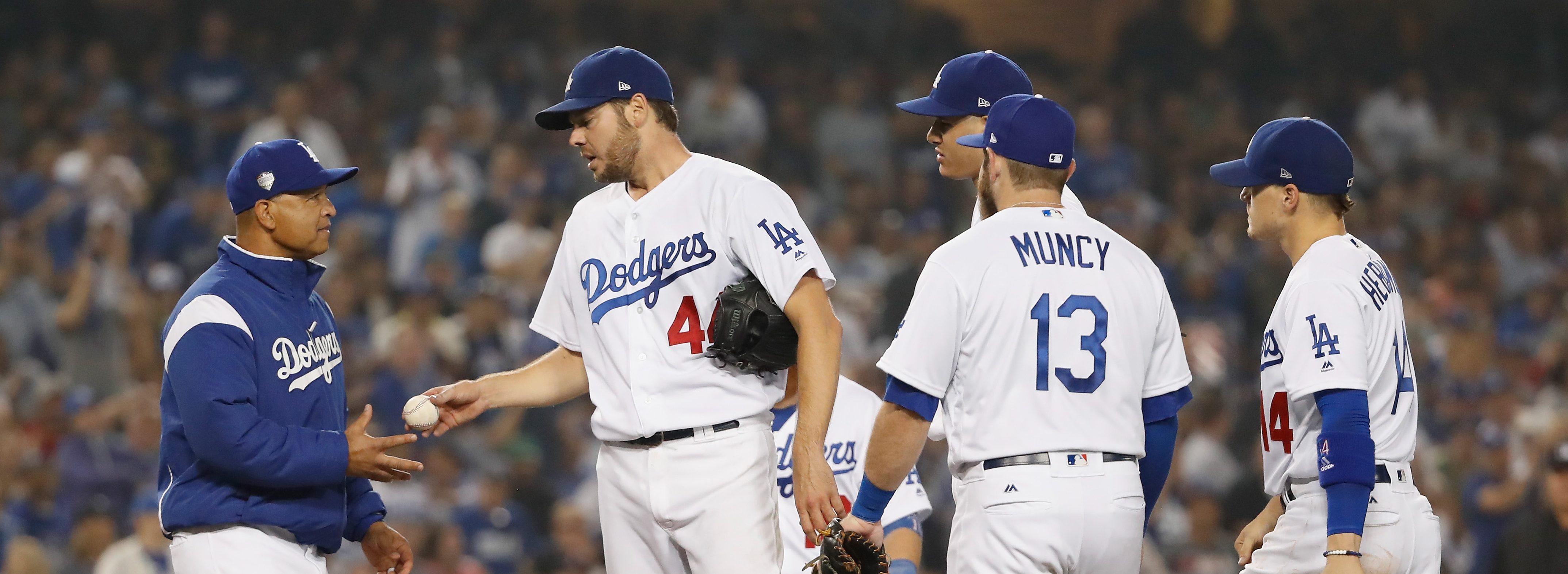 Los Angeles Dodgers manager Dave Roberts takes the ball from Game 4 starter Rich Hill in the 2018 World Series on October 27, 2018. (Photo credit: Sean M. Haffey, Getty Images)