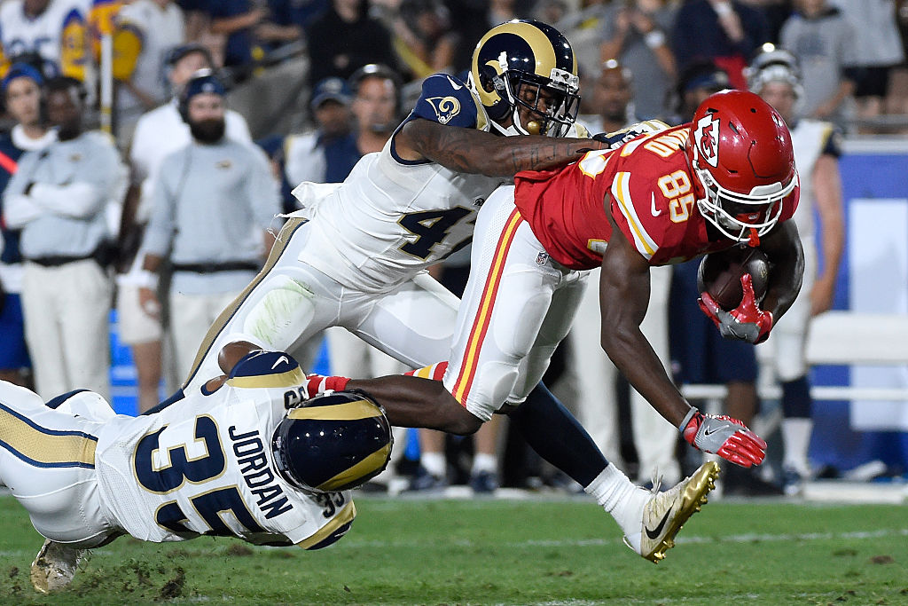 Frankie Hammond Jr. #85 of the Kansas City Chiefs is tackled in the fourth quarter by Marcus Roberson #47 and Mike Jordan #35 of the Los Angeles Rams at Los Angeles Memorial Coliseum on August 20, 2016 in Los Angeles, California.  (Photo by Lisa Blumenfeld/Getty Images)