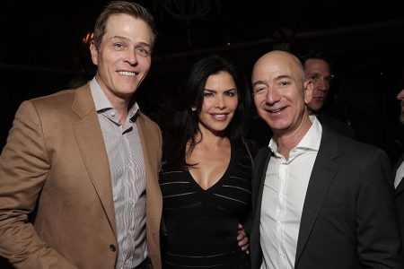 Lauren Sanchez poses with her then-husband Patrick Whitesell (left), and future lover, Amazon CEO Jeff Bezos, at Jeff Bezos and Matt Damon's "Manchester By The Sea" Holiday Party on December 3, 2016 in Los Angeles, California.  (Photo by Todd Williamson/Getty Images for Amazon Studios)