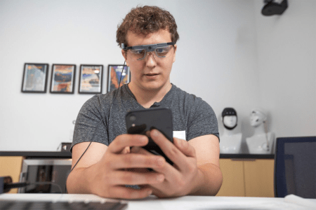 A volunteer wears eye-tracking glasses as he browses Vrbo.