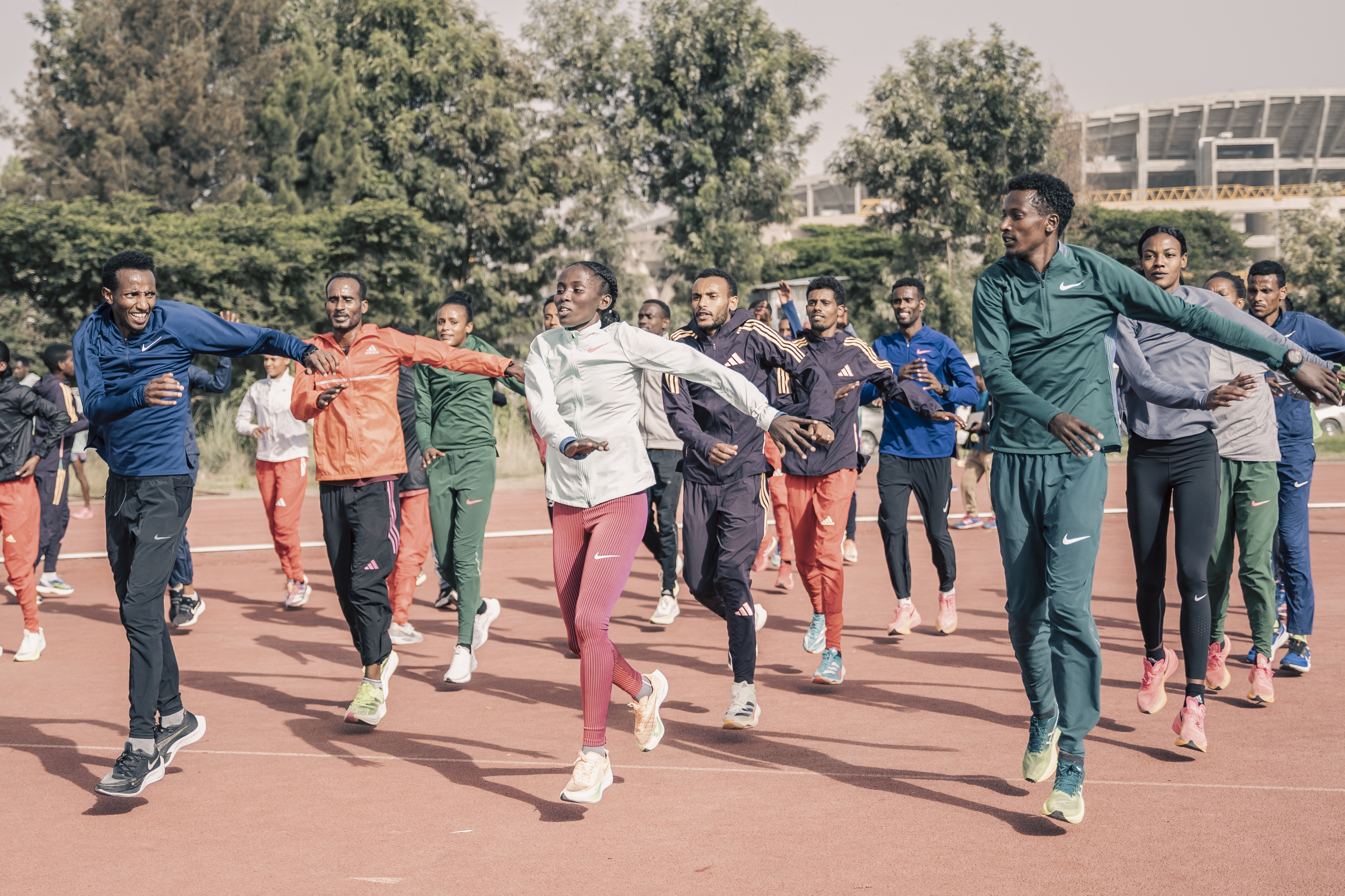 A group of Olympic runners warming up before a run.