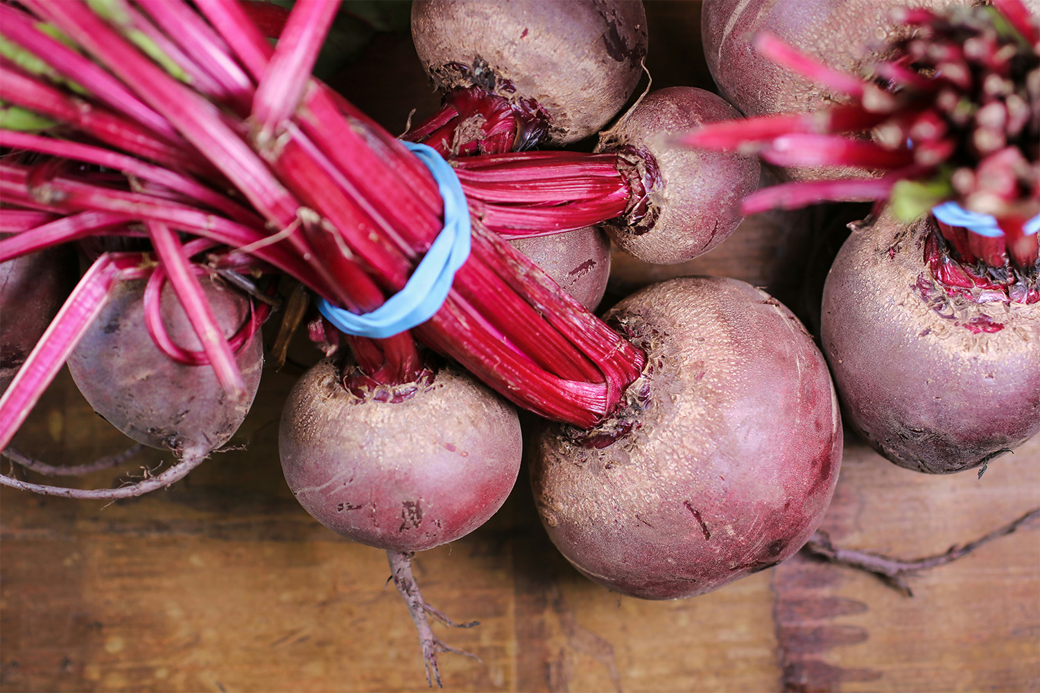 A photo of beets taken from the ground and tied together.