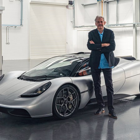 Gordon Murray standing next to his new supercar the T.50