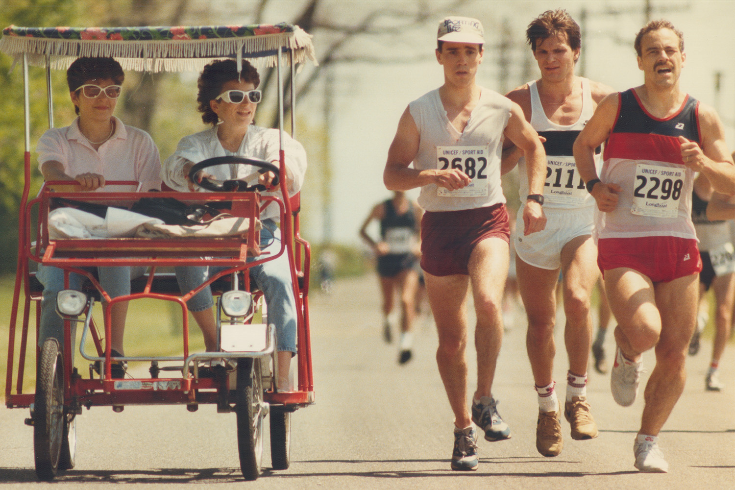 A group of men running a race in the heat.