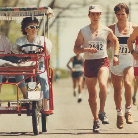 A group of men running a race in the heat.