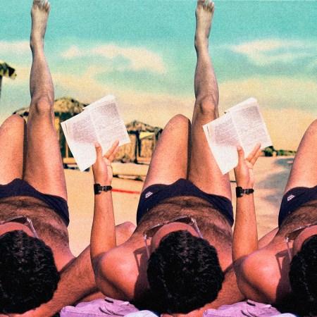 Man reading on the beach during summer