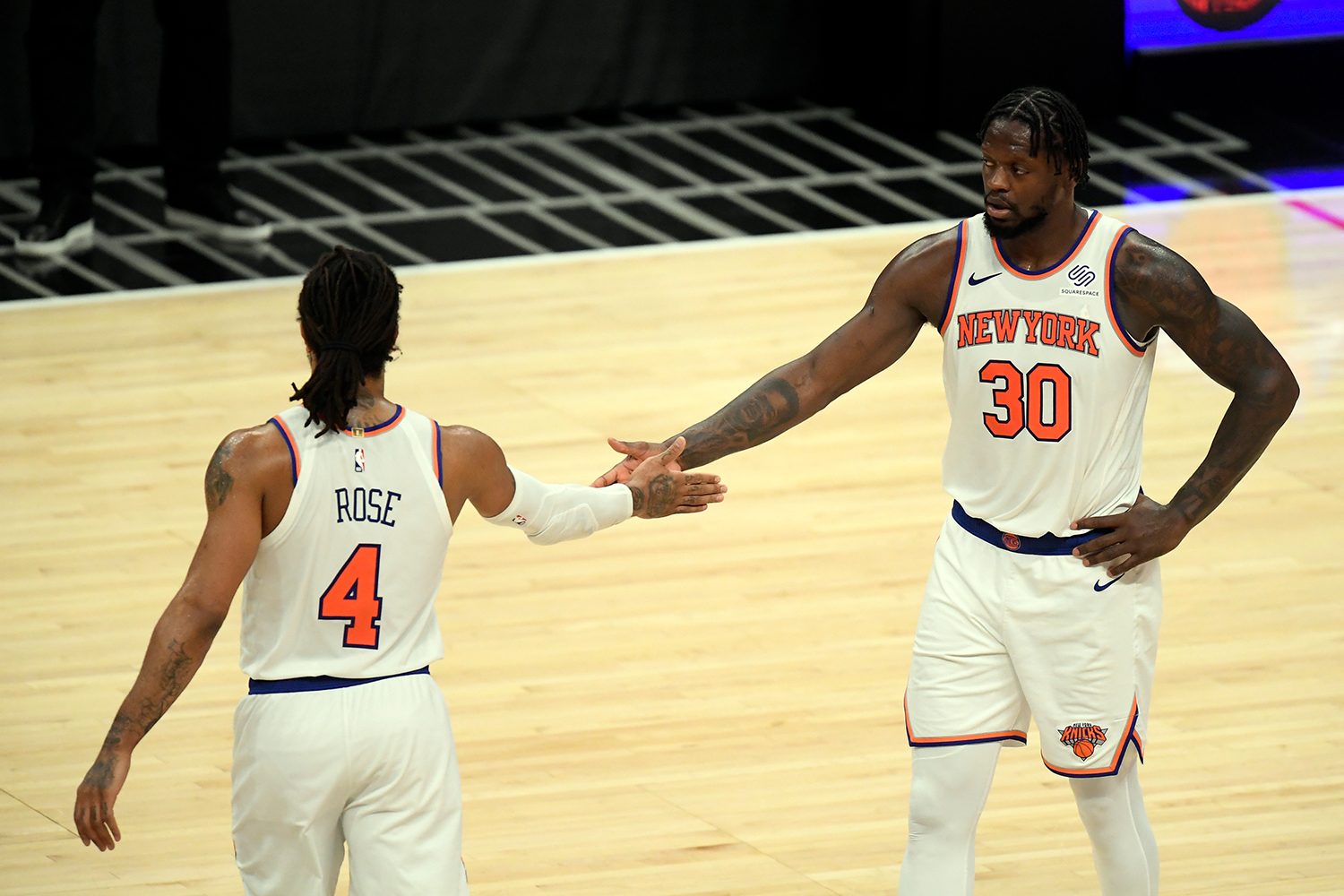 Julius Randle #30 of the New York Knicks and Derrick Rose #4 celebrate after defeating the Los Angeles Clippers