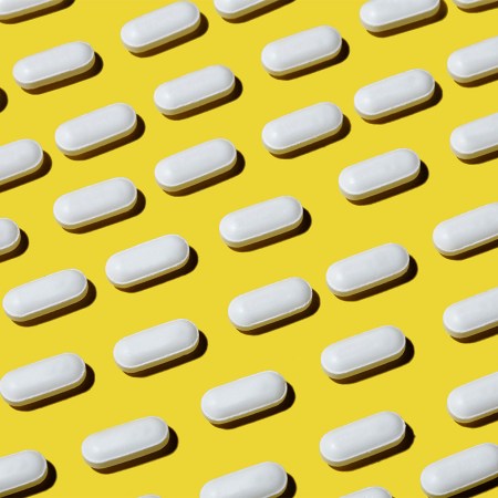 white pills on yellow background