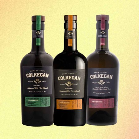 three bottles of various Colkegan single malts, a smoky whiskey from New Mexico