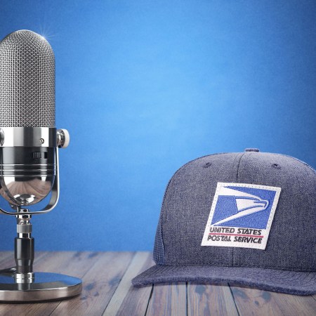 A desktop microphone and a US Postal Service hat