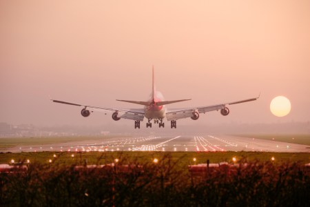 Boeing 747 airplane Landing into sunset