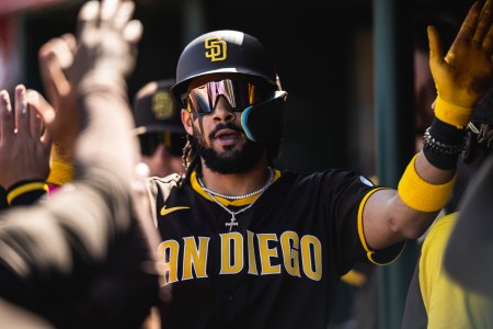 Fernando Tatis Jr. of the San Diego Padres celebrates in the dugout after hitting a home run during a spring training game against the Los Angeles Angels