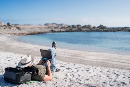 A digital nomad lounging on the beach