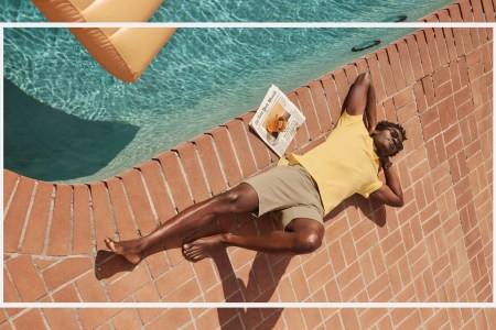 a model in Mack Weldon sale clothes laying by a pool