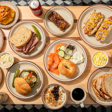 Spread of sandwiches and other toppings and drinks across a table