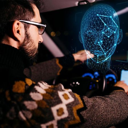 A man driving a car while his face gets scanned by facial recognition technology