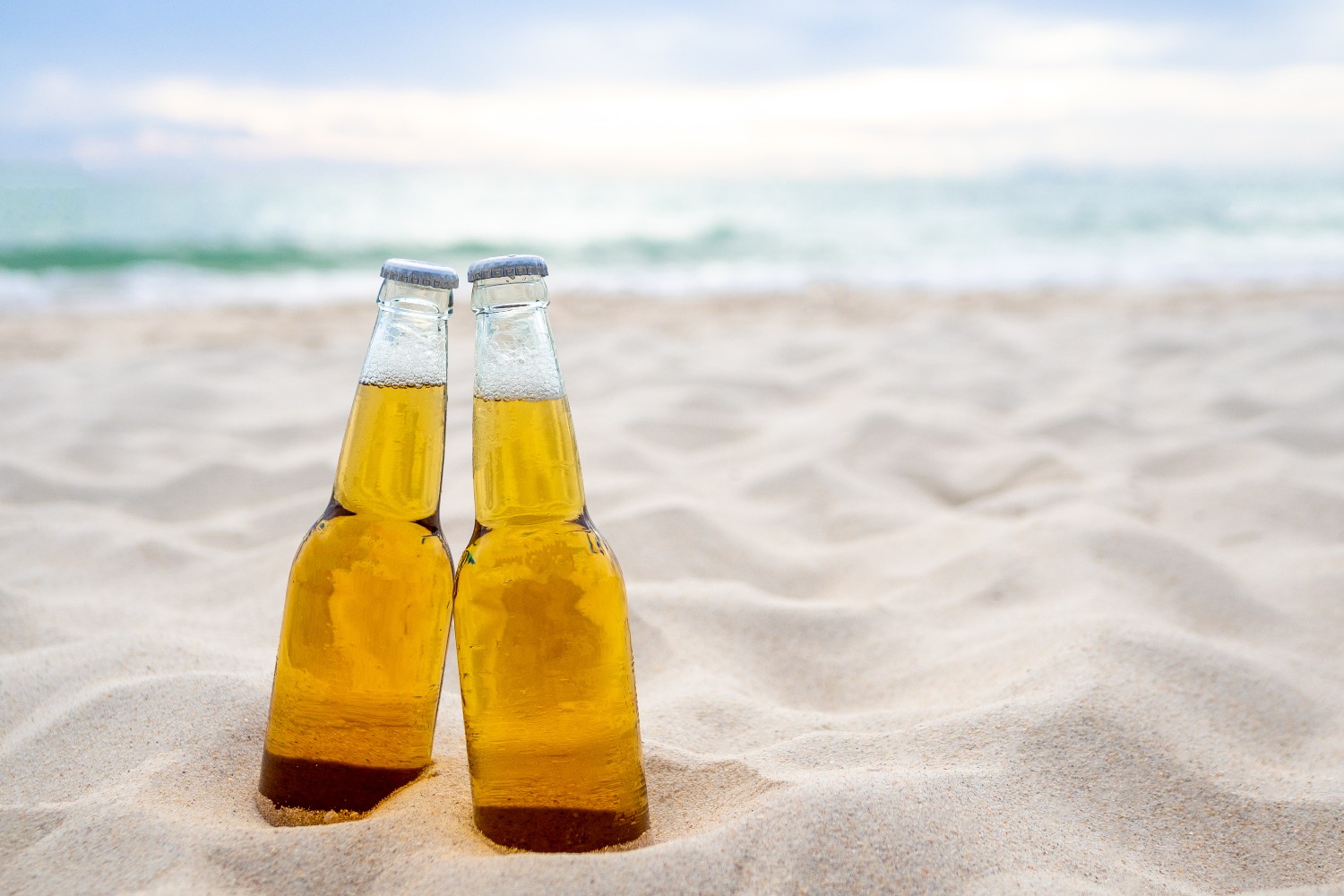 Beer bottles in the sand