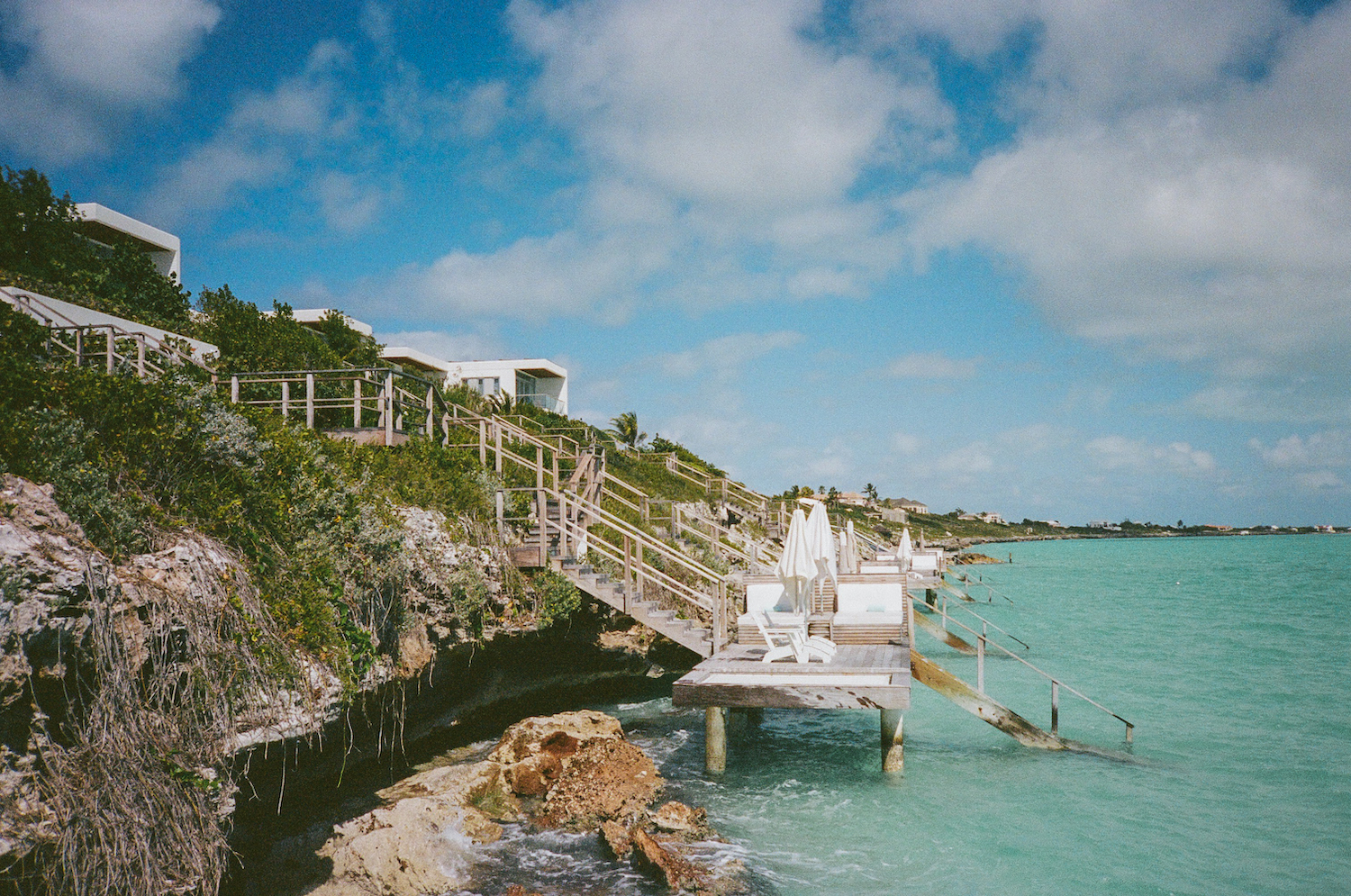 a string of villas perched on cliffs on the caribbean sea