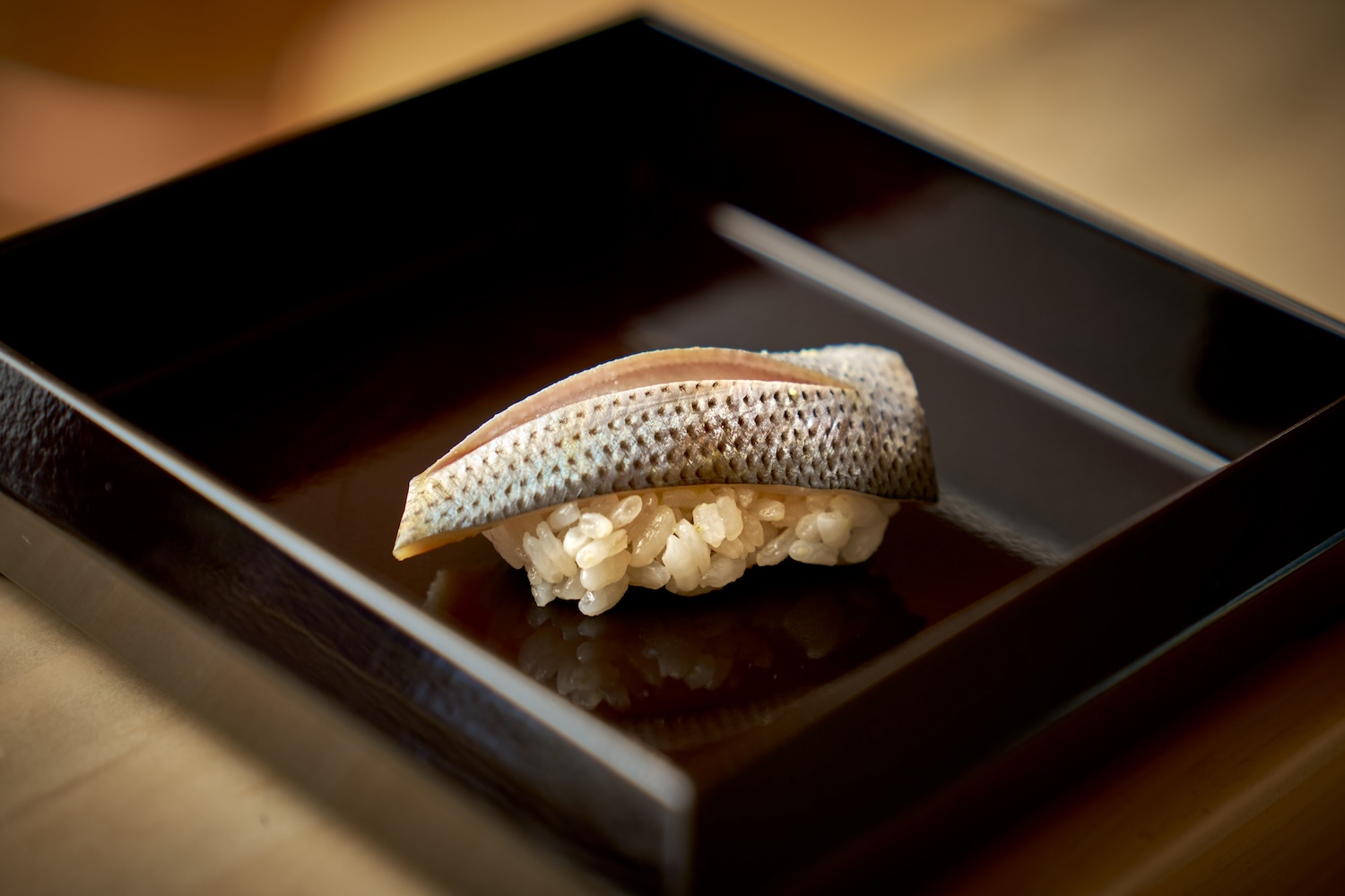 piece of sushi on brown plate