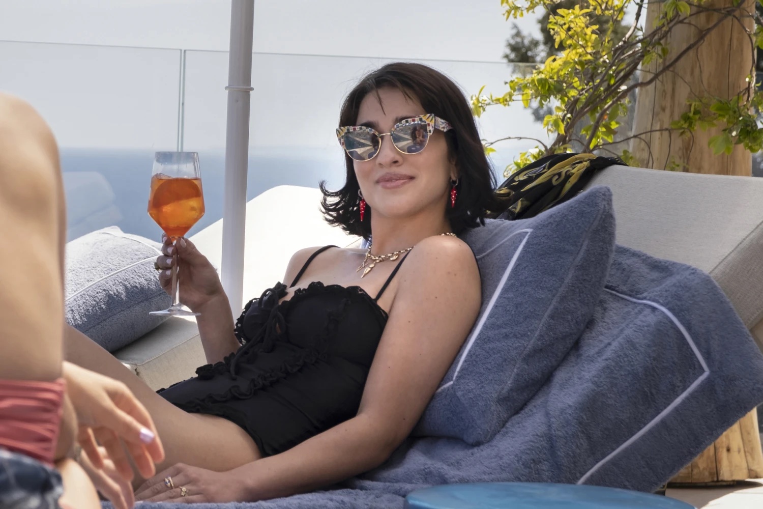 lucia from white lotus drinking an aperol spritz