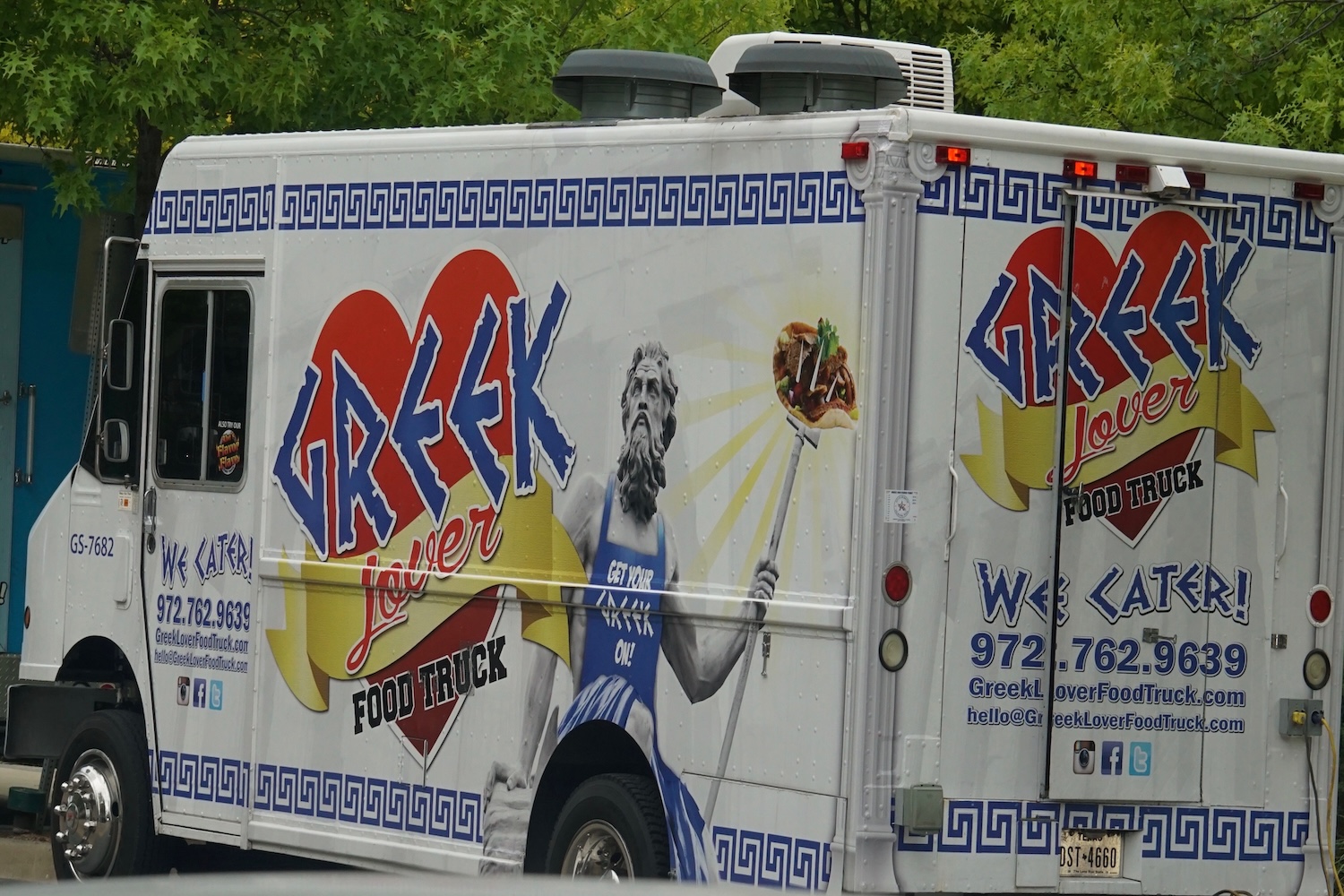 food truck with a heart logo and greek marble statue wearing an apron