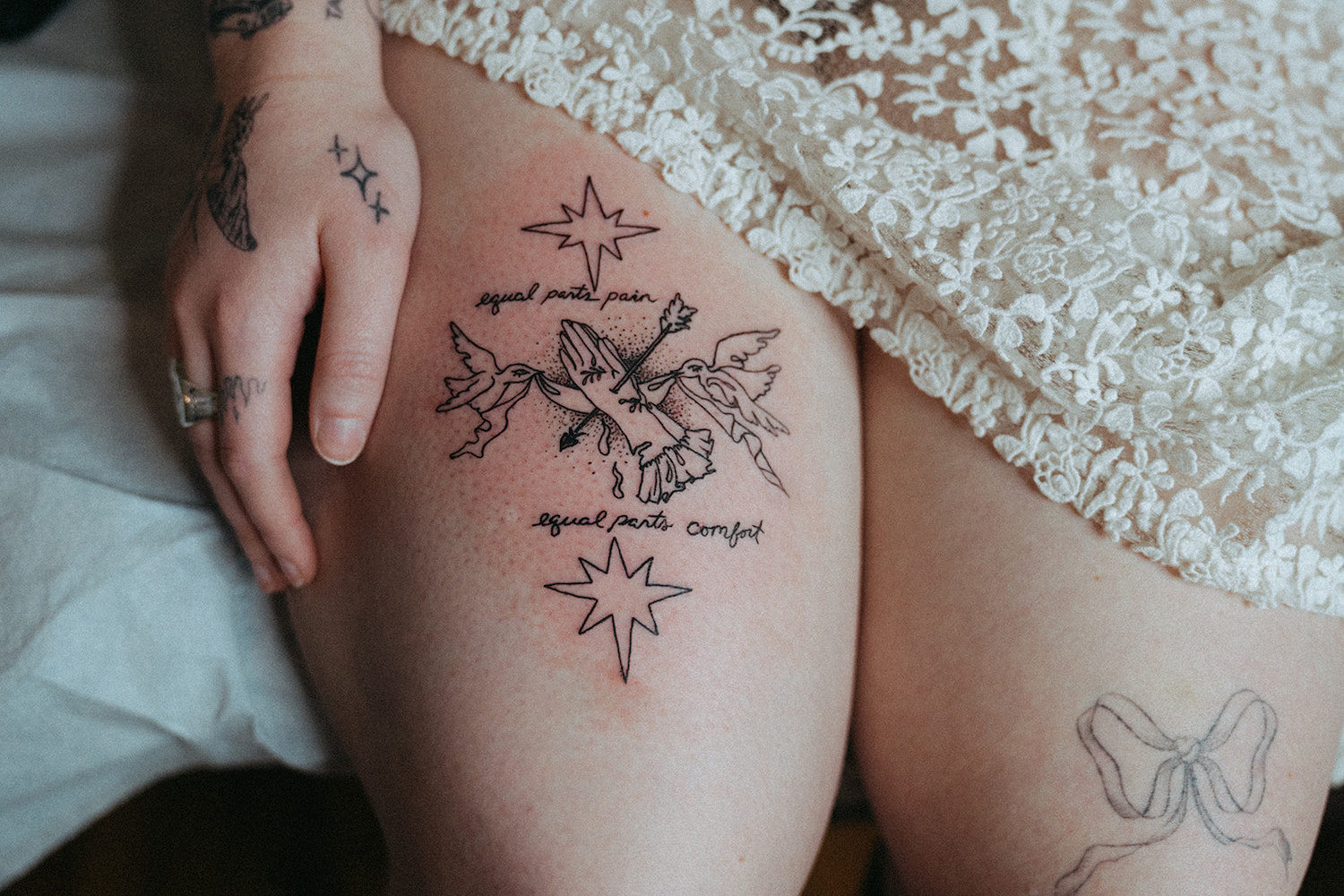 Close-up of tattoos on thighs and along a hand