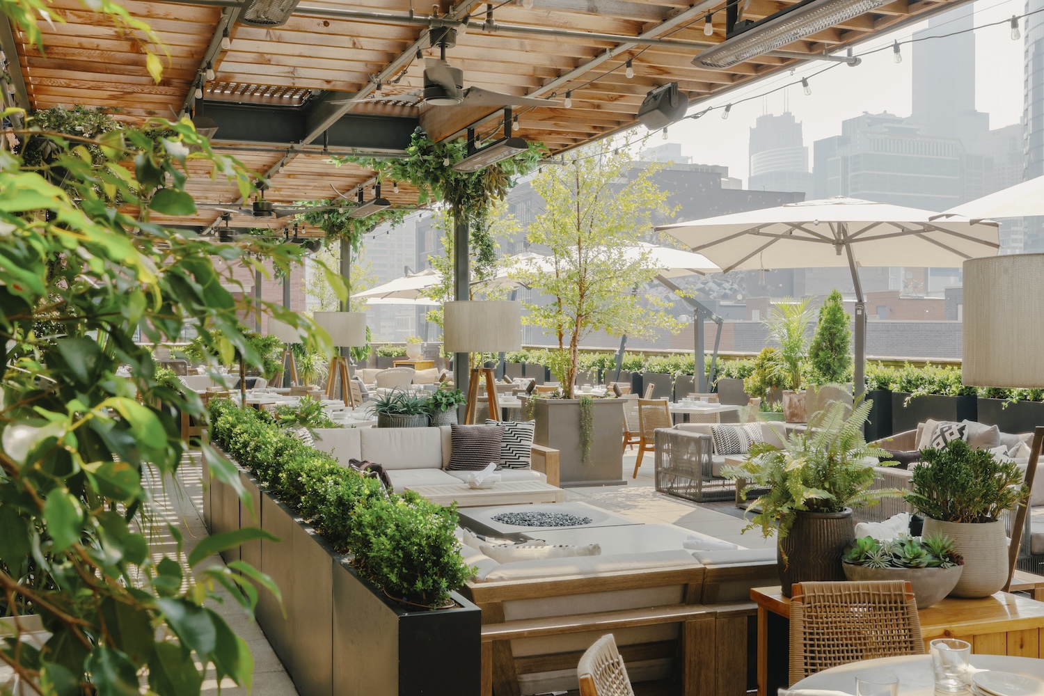 Aba's Chicago location features a massive patio filled with couches, tables, and fire pits