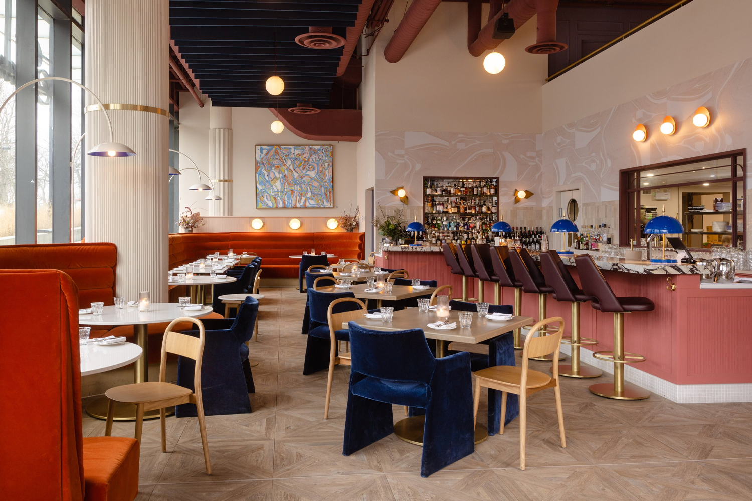 a restaurants with a pink bar and navy blue and red furniture