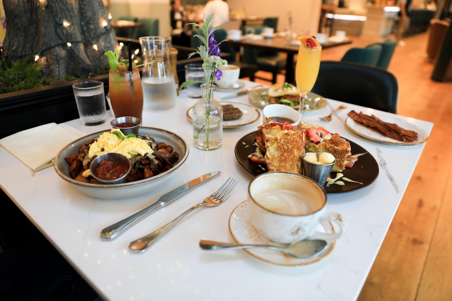 A brunch spread at Laurel, foregrounded by their "Italian French Toast"