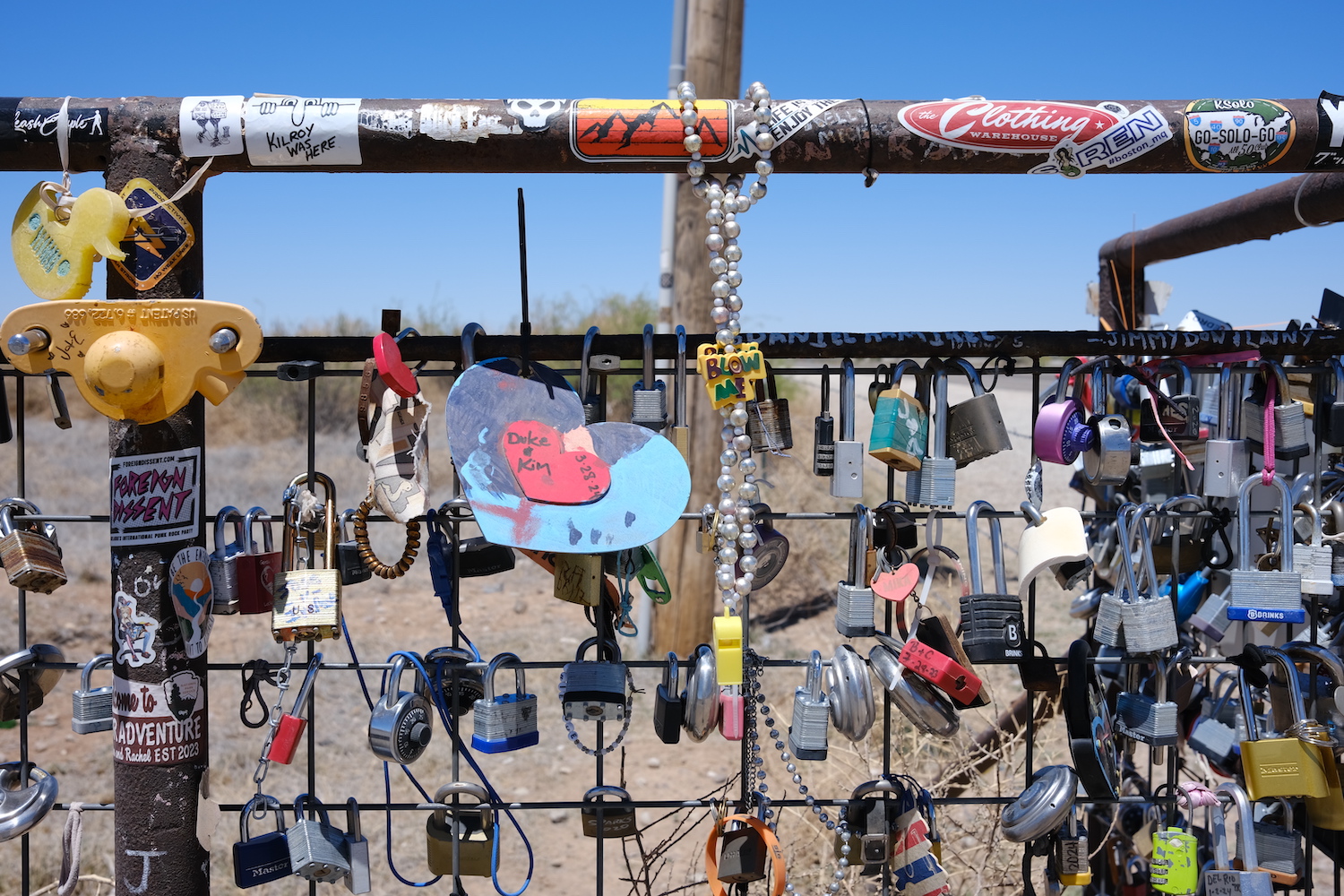 Locks adorn the fence beside Prada Marfa, a permanent art piece located in the West Texas desert