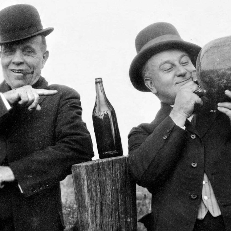 Two men with a jug of moonshine, ca. 1915