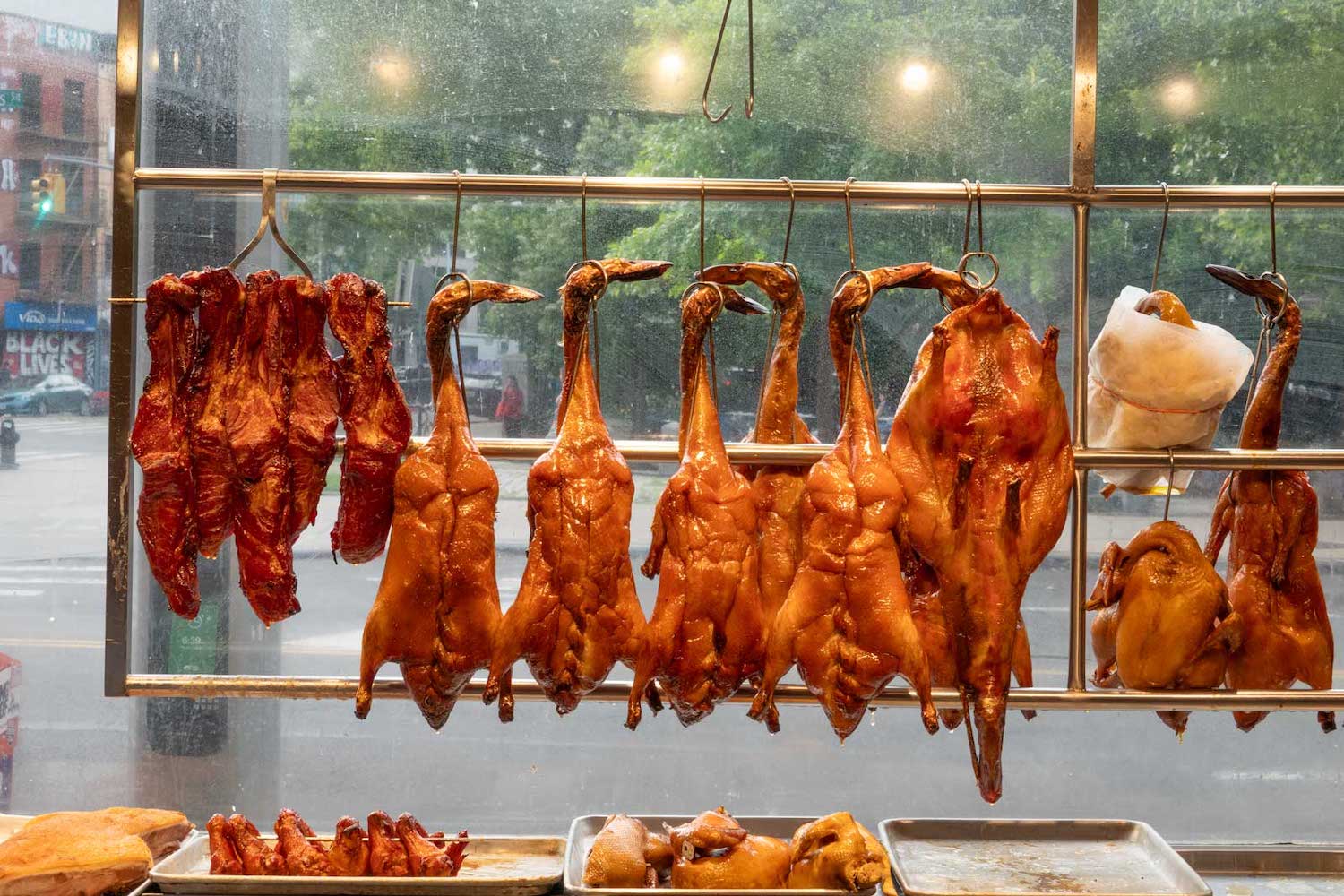 The duck hanging in Wonton King's East Broadway window are served with bao, scallion and cucumber