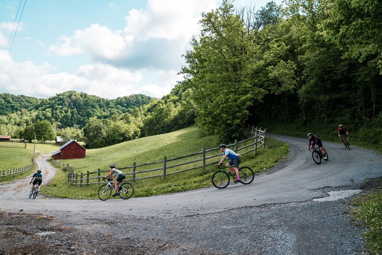 A photo of bikers rounding a farmland corner in Tennessee, which is trying to become America's next cycling paradise