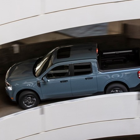 A Ford Maverick Hybrid driving down a parking garage ramp. We dig into why this pickup truck is being ignored by most Americans, despite it being near-perfect.