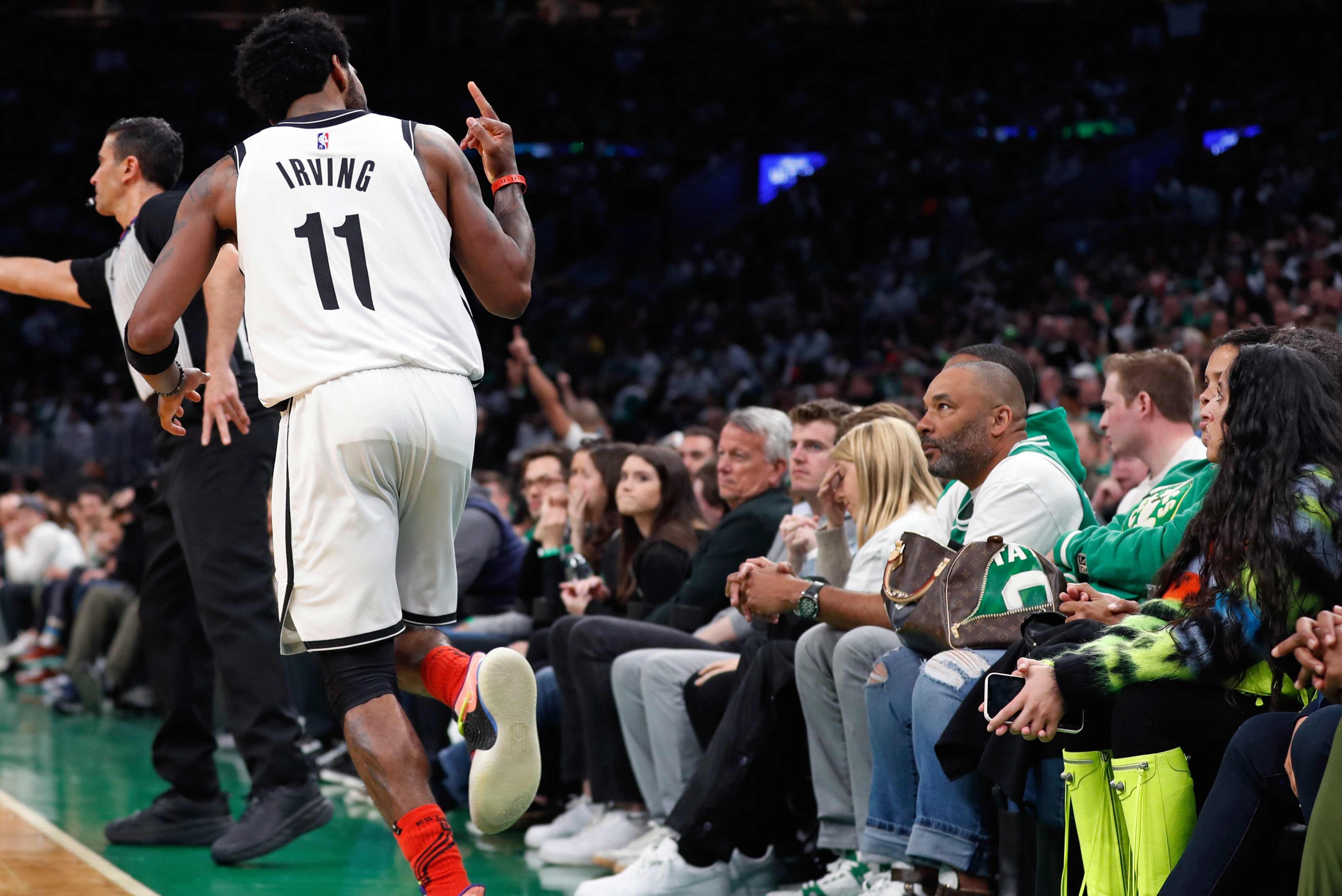 Kyrie Irving flips fans the bird in Boston in 2022.