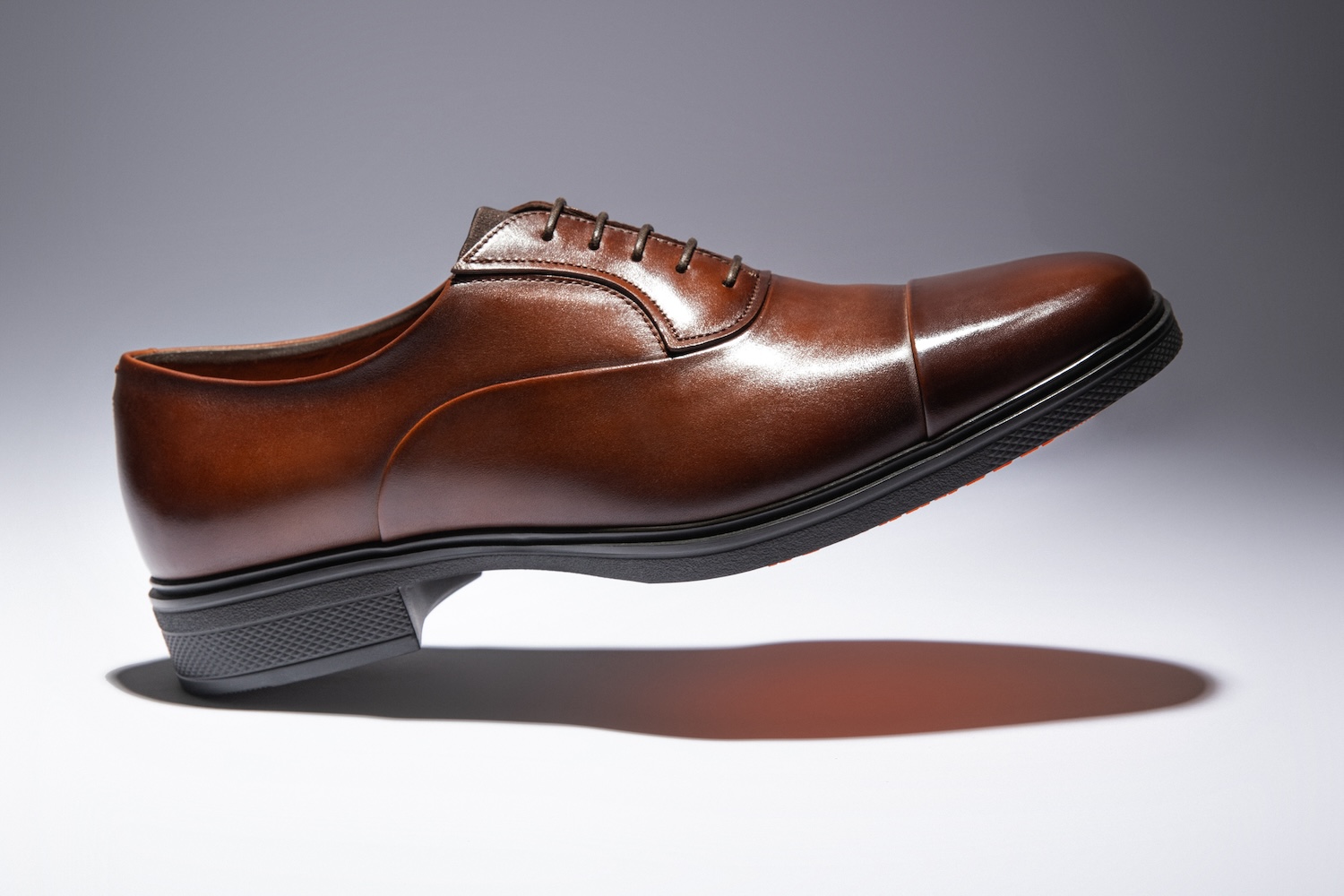 Promotional image of a brown leather shoe from Santoni's Easy collection. 