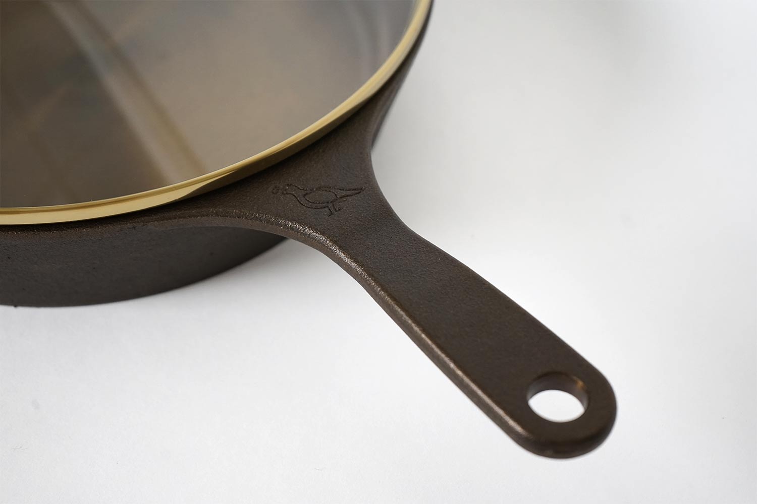 The handle of a Smithey No. 10 Cast Iron Skillet, one of our favorite American-made products