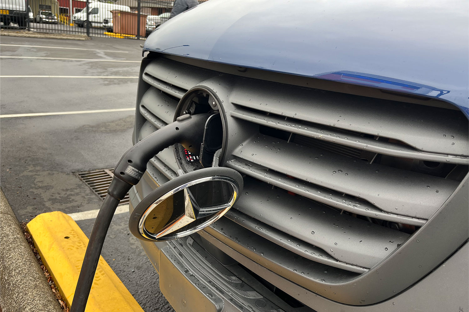 The charging port on the Mercedes-Benz eSprinter, located under the emblem in the front grille