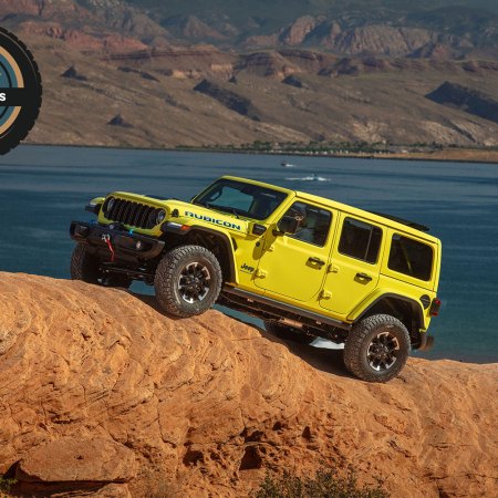 The 2024 Jeep Wrangler 4xe Rubicon X driving on a rocky hill