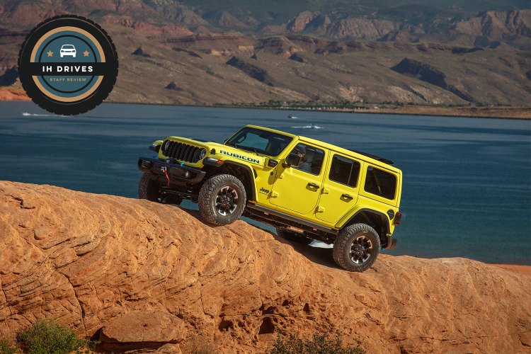 The 2024 Jeep Wrangler 4xe Rubicon X driving on a rocky hill