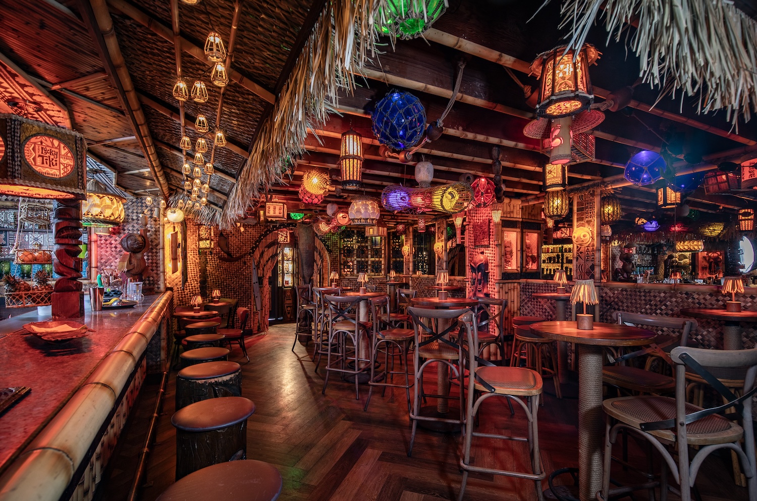 Interior of Lucky Tiki, decorated with bamboo decor and colorful lighting 